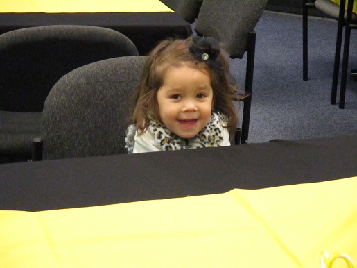 A little girl smiling at the Christmas Party